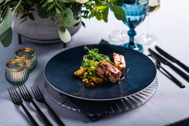 Slow-cooked pork belly, cherry mole, beans, ratte potatoes, and pea shoot salad