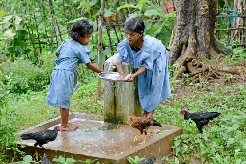 Banita and Bobi washing their plates after having their mid-day meal at school in Lunduriguda village. The running clean water is provided by Gram Vikas. Gram Vikasâ€™ founders came to Orissa in the early 1970s as student volunteers to serve victims of a devastating cyclone. Their extensive activism and relief work motivated them to form Gram Vikas, which was registered on January 22, 1979, and currently serves more than 3,89,333 people in 1196 habitations of 25 districts in Odisha. Through its direct outreach programmes Gram Vikas works in 943 villages across 23 districts covering 59,132 families of which 39% are adivasis, 14% are dalits and the remainder are from general castes, mostly poor and marginal farmers.